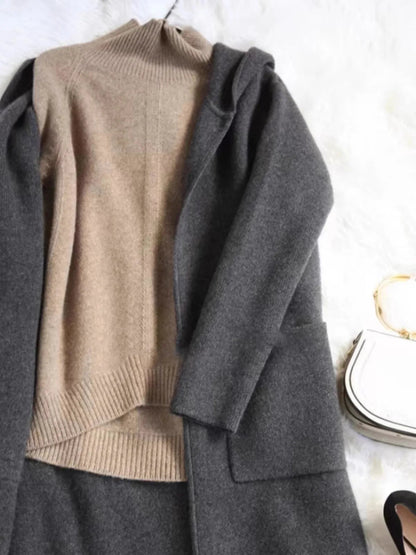 Women's Oversized Cashmere Turtleneck Knit Sweater – Three-quarter view of brown cashmere turtleneck styled with trousers
