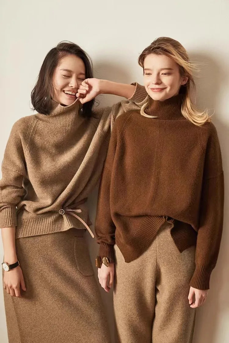 Women's Oversized Cashmere Turtleneck Knit Sweater – Model wearing gray cashmere turtleneck tucked into wide-leg pants